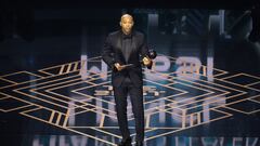 Thierry Henry reacts on stage after collecting The Best FIFA Men's Player award on behalf of Argentina and Inter Miami forward Lionel Messi during the Best FIFA Football Awards 2023 ceremony in London on January 15, 2024. (Photo by Adrian DENNIS / AFP)