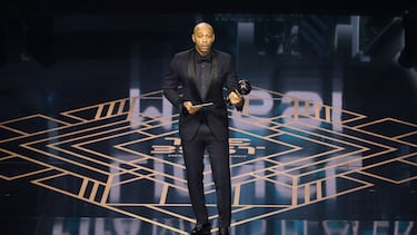 Thierry Henry reacts on stage after collecting The Best FIFA Men's Player award on behalf of Argentina and Inter Miami forward Lionel Messi during the Best FIFA Football Awards 2023 ceremony in London on January 15, 2024. (Photo by Adrian DENNIS / AFP)