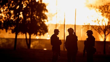 Members of the Army and the Civil Protection department watch the fire at the Central de Abastos wholesale market in Mexico City, Mexico April 6, 2023. REUTERS/Luis Cortes