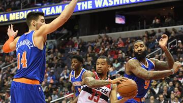 Jan 31, 2017; Washington, DC, USA; Washington Wizards guard Trey Burke (33) looks to pass inbetween New York Knicks center Willy Hernangomez (14) and center Kyle O'Quinn (9) during the fourth quarter at Verizon Center. Washington Wizards defeated New York Knicks 117-101. Mandatory Credit: Tommy Gilligan-USA TODAY Sports
