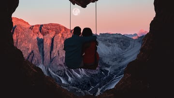 Composition of the Alps mountains during sunset with full moon and couple on swing from a heart shape cave. PAREJAS AMOR PAREJAS SENTIMENTALES NOVIOS