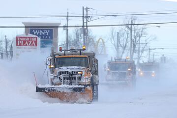 Snow plows clear the roads following a winter storm that hit the Buffalo region in Lancaster, New York.