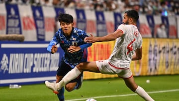 SUITA, JAPAN - JUNE 14: Takefusa Kubo of Japan takes on Ali Elabdi of Tunisia during the international friendly match between Japan and Tunisia at Panasonic Stadium Suita on June 14, 2022 in Suita, Osaka, Japan. (Photo by Kenta Harada/Getty Images)