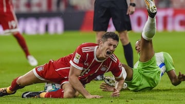 Bayern Munich&#039;s Polish striker Robert Lewandowski is fouled by Wolfsburgx91s French defender Marcel Tisserand during the German First division Bundesliga football match FC Bayern Munich vs VfL Wolfsburg in Munich, southern Germany, on September 22, 2