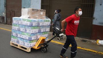 LIMA, PERU - AUGUST 28: A worker wearing a protective mask pulls a trolley on August 28, 2020 in Lima, Peru. According to the INEI (National Institute of Statistics and Informatics), Peru's economy severely contracted between April and June when strict confinement measures were implemented to stop spread of coronavirus. The country's GDP fell 30.2% in comparison to the same period last year, suffering the largest slump registered. (Photo by Raul Sifuentes/Getty Images)