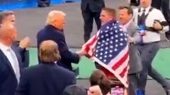 NCAA wrestler wraps himself in the American flag, salutes Trump, and shakes his hand in newly surfaced footage
