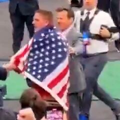NCAA wrestler wraps himself in the American flag, salutes Trump, and shakes his hand in newly surfaced footage