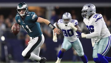 ARLINGTON, TX - NOVEMBER 19: Carson Wentz #11 of the Philadelphia Eagles is pursued by Maliek Collins #96 of the Dallas Cowboys in the first half of a football game at AT&amp;T Stadium on November 19, 2017 in Arlington, Texas.   Ronald Martinez/Getty Images/AFP
 == FOR NEWSPAPERS, INTERNET, TELCOS &amp; TELEVISION USE ONLY ==