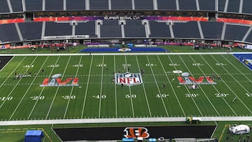 Workers prepare the field one day before Super Bowl LVI between the Los Angeles Rams and the Cincinatti Bengals at So-Fi Stadium in Inglewood, California.