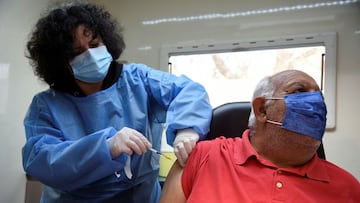 Panagiotis Siankouris, 69, a member of the Roma community, receives a dose of the Pfizer-BioNTech vaccine against the coronavirus disease (COVID-19) by nurse Dimitra Mpatzou, 47, in a mobile unit of the National Public Health Organisation (EODY) in the neighbourhood of Dendropotamos, in Thessaloniki, Greece, January 7, 2022. REUTERS/Alexandros Avramidis