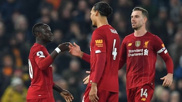 Liverpool&#039;s Senegalese striker Sadio Mane (L) celebrates with Liverpool&#039;s Dutch defender Virgil van Dijk (C) and Liverpool&#039;s English midfielder Jordan Henderson (R) after scoring the opening goal during the English Premier League football m