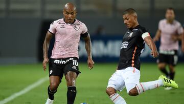 Sport Boys' Hiener Chavez (L) and Ayacucho's Minzum Quina (R) vie for the ball during their Sudamericana Cup first round second leg all-Peruvian football match at the National stadium in Lima, on March 16, 2022. (Photo by ERNESTO BENAVIDES / AFP)