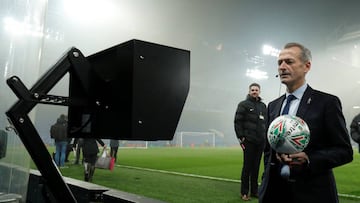 Referee Martin Atkinson looks at the VAR machine by the pitch before the match