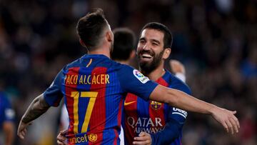 Barcelona's forward Paco Alcacer (L) is congratulated by his teammate Barcelona's Turkish midfielder Arda Turan after scoring during the Spanish Copa del Rey (King's Cup) round of 32 second leg football match FC Barcelona vs Hercules CF at the Camp Nou stadium in Barcelona on December 21, 2016. / AFP PHOTO / JOSEP LAGO