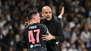Manchester City's English midfielder #47 Phil Foden celebrates his team's second goal with Manchester City's Spanish manager Pep Guardiola during the UEFA Champions League quarter final first leg football match between Real Madrid CF and Manchester City at the Santiago Bernabeu stadium in Madrid on April 9, 2024. (Photo by JAVIER SORIANO / AFP)