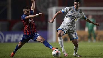 Paraguay&#039;s 12 de Octubre Victor Caceres (R) and Argentina&#039;s San Lorenzo Julian Palacios vie for the ball during the Copa Sudamericana football tournament group stage match at the Pedro Bidegain Stadium, also known as Nuevo Gasometro, in Buenos A