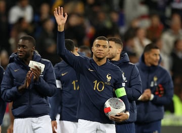 France's Kylian Mbappé celebrates with the match ball after scoring a hat-trick.