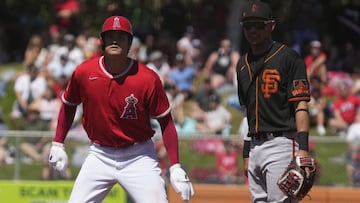 Mar 27, 2022; Tempe, Arizona, USA; San Francisco Giants shortstop Mauricio Dubon (1) looks for the ball as Los Angeles Angels designated hitter Shohei Ohtani (17) tags the base during a spring training game at Tempe Diablo Stadium. Mandatory Credit: Rick 