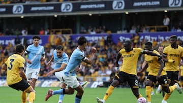 Manchester City's French midfielder #10 Rayan Cherki (3L) scores their fourth goal during the English Premier League football match between Wolverhampton Wanderers and Manchester City at the Molineux stadium in Wolverhampton, central England on August 16, 2025. (Photo by Darren Staples / AFP) / RESTRICTED TO EDITORIAL USE. No use with unauthorized audio, video, data, fixture lists, club/league logos or 'live' services. Online in-match use limited to 120 images. An additional 40 images may be used in extra time. No video emulation. Social media in-match use limited to 120 images. An additional 40 images may be used in extra time. No use in betting publications, games or single club/league/player publications. /