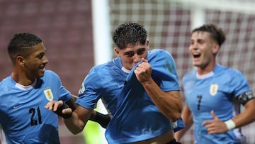 Uruguay's forward #09 Renzo Machado celebrates next to teammates midfielder #21 Jorge Severo and forward #07 Joaquin Lavega after scoring his team's fourth goal during the 2025 South American U-20 football championship match between Uruguay and Paraguay at the Metropolitan of Lara stadium in Cabudare, Lara state, Venezuela on January 27, 2025. (Photo by EDILZON GAMEZ / AFP)