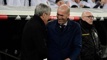 Barcelona's Spanish coach Quique Setien (L) and Real Madrid's French coach Zinedine Zidane greet each other before the Spanish League football match between Real Madrid and Barcelona at the Santiago Bernabeu stadium in Madrid on March 1, 2020. (Photo by J