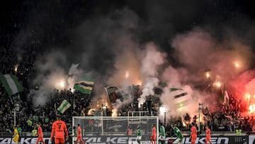 (FILES) In this file photo taken on December 15, 2019 Supporters light flares and wave flags during the French L1 football match between AS Saint-Etienne (ASSE) and Paris Saint-Germain (PSG) at the Geoffroy Guichard Stadium in Saint-Etienne, central Franc