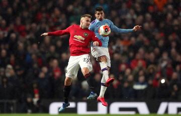 Manchester United's Luke Shaw (L) and Manchester City's Joao Cancelo battle for the ball during match between Manchester United and Manch ester City at Old Trafford.