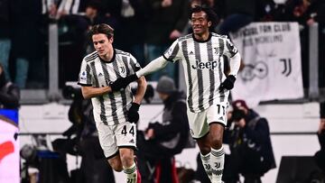 Juventus' Colombian midfielder Juan Cuadrado from Colombia celebrates with Juventus Italian midfielder Nicolo Fagioli after scoring his team's first goal during the Italian Serie A football match between Juventus and Torino at the Juventus Stadium in Turin on February 28, 2023. (Photo by MARCO BERTORELLO / AFP)