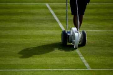 LONDON, ENGLAND - JULY 06:  Groudstaff prepare the court on Centre Court ahead of the start of day nine of the Wimbledon Lawn Tennis 