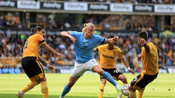 Erling Haaland in action with Ruben Neves and Jonny of Wolverhampton Wanderers.