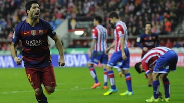 Barcelona's Uruguayan forward Luis Suarez (L) celebrates after scoring a goal during the Spanish league football match Real Sporting de Gijon vs FC Barcelona at El Molinon stadium in Gijon on February 17, 2016.