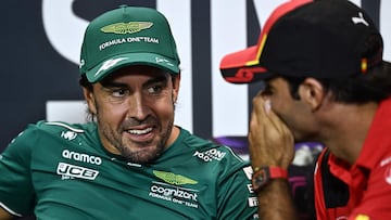 Aston Martin�s Spanish driver Fernando Alonso (L) reacts to something Ferrari's Spanish driver Carlos Sainz Jr (R) said as they take part in a press conference ahead of the Singapore Formula One Grand Prix night race at the Marina Bay Street Circuit in Singapore on September 14, 2023. (Photo by Lillian SUWANRUMPHA / AFP)