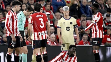 Barcelona's Spanish defender #24 Eric Garcia and Athletic Bilbao's Spanish defender #19 Adama Boiro lay on the ground after falling during the Spanish league football match between Athletic Club Bilbao and FC Barcelona at San Mames Stadium in Bilbao on March 7, 2026. (Photo by ANDER GILLENEA / AFP)