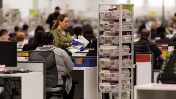 Workers process mail ballots at the Los Angeles County Ballot Processing Center in the city of Industry, California, U.S. October 29, 2024. REUTERS/Mike Blake