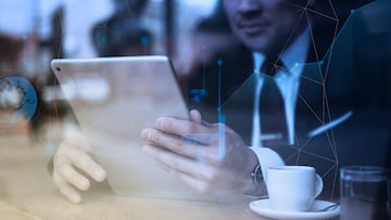 Businessman working on tablet in cafe
