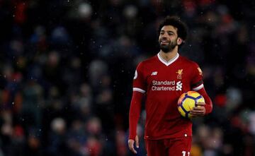 Liverpool, Britain - March 17, 2018 Liverpool's Mohamed Salah celebrates with the match ball after the match