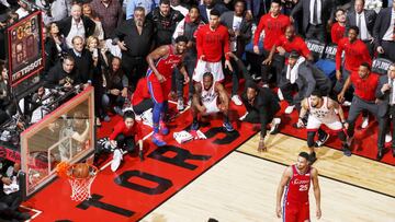 This image released by World Press Photo, Thursday April 16, 2020, by Mark Blinch for NBAE, which won first prize in the Sports Singles category, Kawhi Leonard (squatting, center) of the Toronto Raptors watches his game-winning buzzer-beater shot go into the net, while playing against the Philadelphia 76ers in Game 7 of the Eastern Conference Semifinals of the 2019 National Basketball Association (NBA) Playoffs, at the Scotiabank Arena, Toronto, Canada, on 12 May 2019. (Mark Blinch for NBAE, World Press Photo via AP)