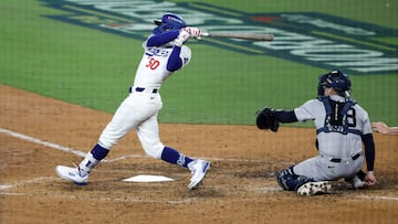 Oct 25, 2024; Los Angeles, California, USA; Los Angeles Dodgers outfielder Mookie Betts (50) hits an RBI sacrifice fly in the eighth inning against the New York Yankees during game one of the 2024 MLB World Series at Dodger Stadium. Mandatory Credit: Kiyoshi Mio-Imagn Images
