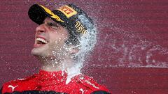 Formula One F1 - British Grand Prix - Silverstone Circuit, Silverstone, Britain - July 3, 2022 Ferrari's Carlos Sainz Jr. celebrates winning the race on the podium REUTERS/Andrew Boyers     TPX IMAGES OF THE DAY