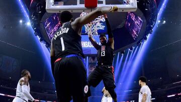 LOS ANGELES, CALIFORNIA - FEBRUARY 28: Paul George #13 of the LA Clippers scores on a dunk in front of Reggie Jackson #1 during a 132- 103 win over the Denver Nuggets at Staples Center on February 28, 2020 in Los Angeles, California. Harry How/Getty Images/AFP
== FOR NEWSPAPERS, INTERNET, TELCOS & TELEVISION USE ONLY ==