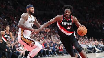 Portland Trail Blazers forward Caleb Swanigan (50) drives on New Orleans Pelicans forward DeMarcus Cousins (0) in a 2017 NBA game at Moda Center.