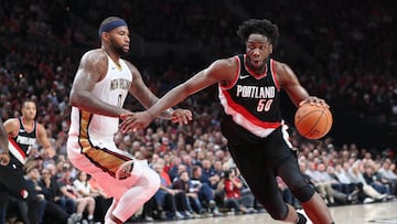 Portland Trail Blazers forward Caleb Swanigan (50) drives on New Orleans Pelicans forward DeMarcus Cousins (0) in a 2017 NBA game at Moda Center.