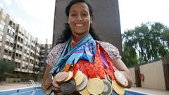 Spain's paralympic swimmer Teresa Perales poses with her 22 medals won during the four Paralympic Games she competed in, at her home in Zaragoza, September 20, 2012. A mother and a former local politician as well as one of a handful of Paralympians with m
