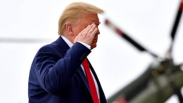 US President Donald Trump salutes military personnel before boarding Air Force One at Joint Base Andrews in Maryland on June 11, 2020. 