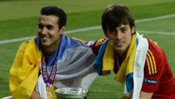 Spanish midfielder David Silva (R) and forward Pedro Rodriguez pose with the trophy after winning the Euro 2012 football championships final match Spain vs Italy on July 1, 2012 at the Olympic Stadium in Kiev. AFP PHOTO / FRANCK FIFE