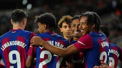 Barcelona's Brazilian forward #11 Raphinha (C) celebrates with teammates after scoring his team's first goal during the Spanish league football match between FC Barcelona and UD Las Palmas at the Estadi Olimpic Lluis Companys in Barcelona on March 30, 2024. (Photo by Pau Barrena / AFP)