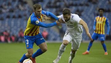 RIYADH, SAUDI ARABIA - JANUARY 11: Toni Lato (3) of Valencia in action against Nacho Fernandez (R) of Real Madrid during the Spanish Super Cup semi-final football match between Real Madrid and Valencia at the King Fahd International Stadium in Riyadh, Saudi Arabia on January 11, 2023. (Photo by Stringer/Anadolu Agency via Getty Images)