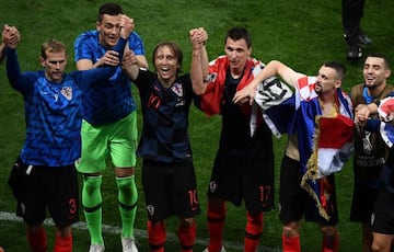 Croatia's midfielder Luka Modric (3L) and Croatia's forward Mario Mandzukic (3R) celebrate after winning the Russia 2018 World Cup semi-final football match between Croatia and England at the Luzhniki Stadium in Moscow on July 11, 2018