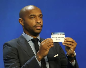 Former player Thierry Henry shows the name of Borussia Dortmund