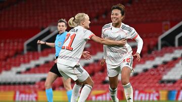 Bayern Munich's Japanese midfielder #18 Momoko Tanikawa (R) celebrates with Bayern Munich's Danish forward #21 Pernille Harder (C) after scoring Bayern Munich's third goal during the UEFA Women's Champions League, Quarter Final first-leg football match between Manchester United and Bayern Munich at Old Trafford in Manchester, north west England, on March 25, 2025. (Photo by Paul ELLIS / AFP)